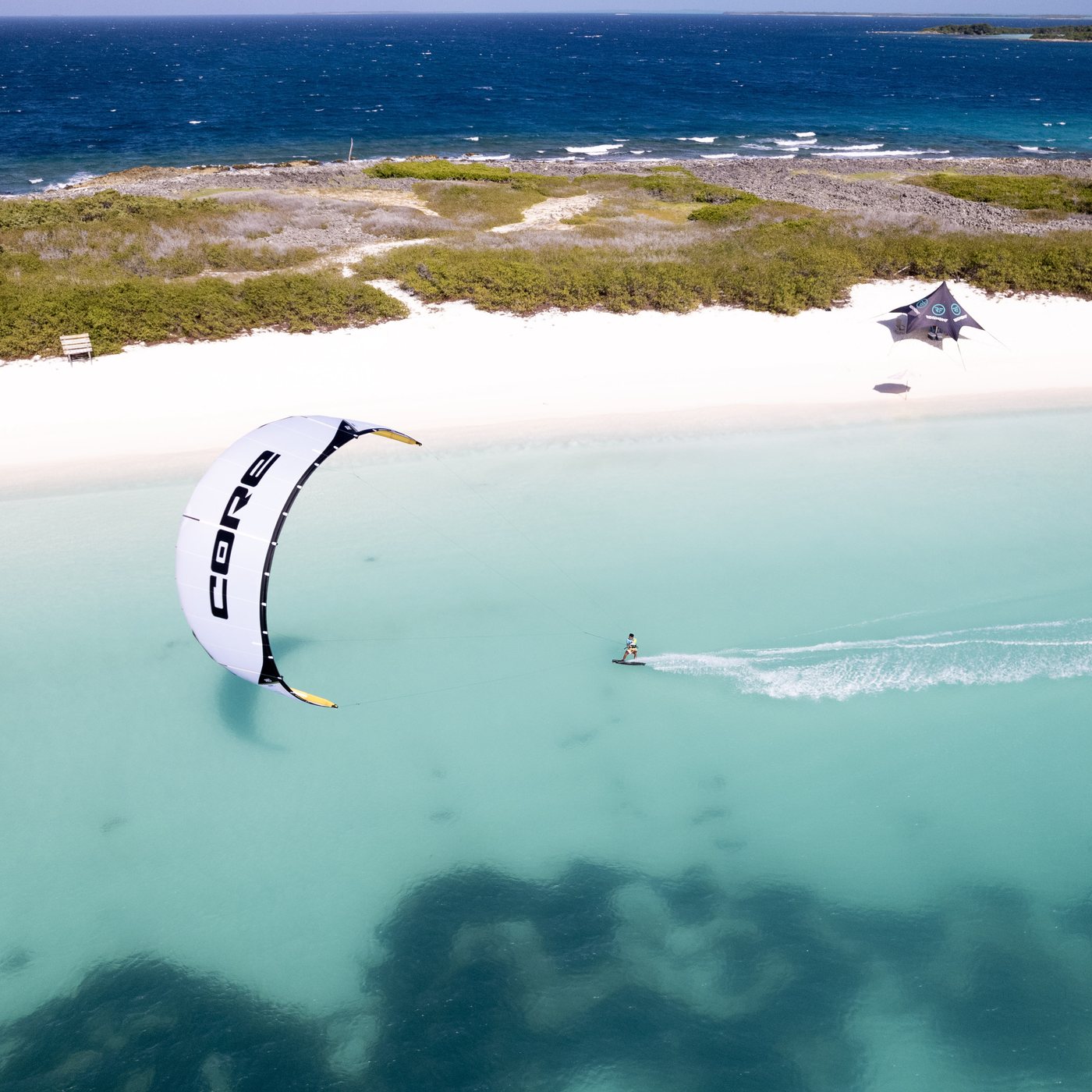 Kiter cruising past a sandbar
